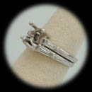 Item 031PO1 - A platinum diamond wedding set. The ring is set with 4 tapered baguettes weighing approx 1.0ct.  The set is 4mm in width and 2.0mm thick and weighs 12 grams. The rings are soldiered together size 5 1/2. Center stone is 8mm. Retail $7,500.00