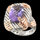 A beautiful amethyst sterling silver and 18K gold ring from Bellarri. The amethyst has a carat weight of 6.30ctw. The head of the ring Dimensions are : 23mm x 20mm. The signature "B" is made of 18K gold with .01ctw. of diamonds in the center.