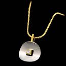 Platinum and 18kt yellow gold pendant from Eddie Sakamoto, with .10ctw of princess cut diamonds.