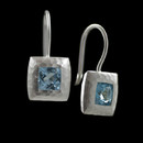 A beautiful pair of sterling and blue topaz bezel earrings from Bastian Inverun. A perfect blend of classic and contemporary with hand hammered finish and gorgeous Swiss blue topaz. 11.2mm wide and 23.8mm long, with 2.04ct in topaz.

