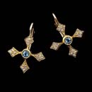These beautiful 18kt yellow gold cross earrings are embellished with diamonds and aquamarine center stones.