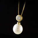 18kt yellow gold 11mm white pearl and diamond pendant and snake chain combination. The diamonds are a .40ctw