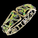 A stunning combination of color and design. This bracelet has an art nouveau inspired design. It was 6 diamonds and 2 emeralds. The piece is made from 18k gold and sterling silver.