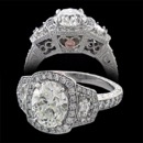 A gorgeous custom platinum oval diamond engagement ring made by Bridget Durnell. This ring features a oval center diamond with two cadillac shield cut diamonds on the side. The undercarriage of the ring has a hand engraved floral pattern along with a pink diamond. Price does not include center diamond. 