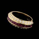 18kt. gold Captiva ring featuring flare sides from Gumuchian, with 1.04 ctw of rubies and .70 ctw of diamonds. The ring has a width of 8.0mm and can be made to fit your size.