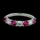Gumuchian Ring 128J1: This beautiful Platinum band by Gumuchian is set with bright pink sapphires and diamonds. The ring contains 4 round sapphires and 3 diamonds along with bezel set diamonds on the top of each prong. The ring measures 3.5m in width so it can easily be worn with another ring as well as by itself. This ring is also available in 18kt white gold. Gumuchian Ring 128J1 jewelry