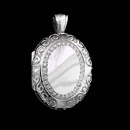 A beautiful 18kt white gold hand engraved scroll design locket by master English jeweler Charles Green. This oval shaped locket features 0.42 carats of fine full cut diamonds. The locket measures 28mm x 23mm.