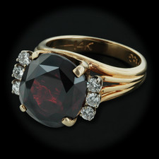 A stunning 14kt yellow gold and almandite garnet ring. The ring is set one oval faceted 10.18ct garnet, and six full cut diamonds weighing .30cts.