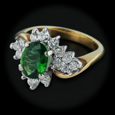 This gorgeous 18kt yellow gold ring is set with .60ctw of diamonds and also set with .60 cts. of green tourmaline with a width of 14mm and a size of 6.