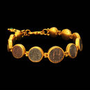 Gurhan Bracelet 13GG4: One-of-a-kind Coin Bracelet from Gurhan. Ancient coins surrounded by 24-karat gold. The graduated piece holds eleven coins ranging in size from 10 to 15mm. An emerald on lobster clasp and extension chain from 7" to 9" long. Gurhan Bracelet 13GG4 jewelry