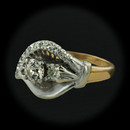 Item 161PO1 - This non-stamped two tone calla lily design ring is set with .65cts of varying cut diamonds features single cut diamonds 11 total set around the outer leaf edge. The larger of two main stones is a european cut while the smaller is a more updated full cut round. The finger size is 6. The diamond weight is approximate.