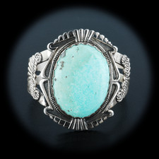 A gorgeous sterling silver motif design bracelet. This 1960's era vintage piece has a single large light blue turquoise stone in the center measuring 1 3/4