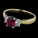 Three stone ruby ring from Spark, set in 18 karat yellow gold. The ring is set with a 0.90 carat ruby and 0.34 carats in round diamonds. 
