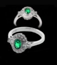 Beautiful art deco Beverley K ring with a bold oval natural emerald  encircled by .28ct diamonds. The square diamonds displayed at the front give this fashion ring a unique but simple art deco appearance. The band for this ring comes in platinum or 18k gold.