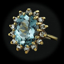 A gem quality aquamarine.  This ring is 18kt yellow gold and contains a 3.42ct. oval gem quality aquamarine surrounded by .45ct. VS F-G total weight in diamonds.  Size 6  16mm at the widest.