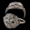 Item 32EB1 - A truly beautiful example of Edwardian  craftsmanship. This platinum ring features two old European cut diamond center stones with an approximate total weight of 2.13 carats. The diamonds range from VS2 to SI1 in clarity and F/G in color. In addition are eight smaller old European cut diamonds weighing 0.24 carats in total and twenty two single cut diamonds weighing 0.32 carats.