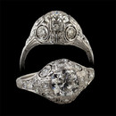 Item 33EB1 - This ring reflects true Edwardian style craftsmanship. The center of this platinum ring is set with a beautiful bright old European cut diamond weighing approximately 1.01 carats. The center diamond has been estimated at VVS2 in clarity and F in color. In a blaze around the center diamond are eight old European cut diamonds and twenty two single cut diamonds.