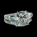 Item 34II1 - Beautiful platinum and diamond engagement ring and matching wedding band. The ring is set with 2 bullet shaped diamonds weighing .66ct total. This ring is made for a 7.5mm center stone. The wedding band contains 3 round brilliant diamonds and 2 tappered baguette diamonds for a total diamond weight of .27ct. Size 6.75, gram weight 10.5