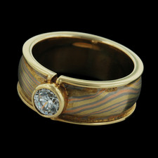 This intriguing engagement ring by George Sawyer is a fusion of 18 kt yellow, red, and gray gold. 
