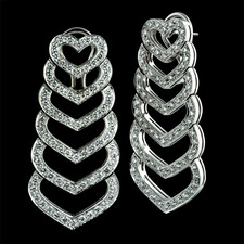 These beautiful 18kt white gold "Heart" earrings by Gumuchian contain 158 diamonds for a total diamond weight of 3.43ct. These earrings hang 1 3/4 inches in length and are 7/8 inches across. The post back with omega clips help to keep the earrings secure.
