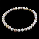 A beautiful strand of multicolored fresh water pearls. The strand measures 17 inches in overall length. The pearls are 12mm in diameter. The fluted ball clasp is 14 karat yellow gold.