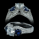 Spark engagement ring with two heart shape sapphires weighing 1.30carats in total.  Set in 18kt white gold with round diamonds totaling 0.53 carats in total. The ring accommodates a center diamond from 1.00 to 2.00 carats. Center stone not included.