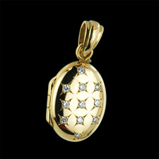 18kt. yellow gold oval shaped locket. This beautiful quality locket contains .11ct in full cut fine diamonds. The oval measures 12 X 17mm and makes a beautiful treasured pendant.