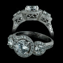 A stunning platinum three stone halo design from Durnell. Features .54ct in side stones and an additional .50ct in melee. Flowing hand engraving and filigree work complete this timeless setting. Center stone sold separately.