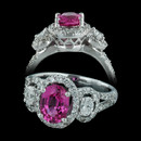 This three stone engagement ring from Spark is set with a 1.60ct oval pink sapphire center and 2 oval diamonds weighing 0.34 carats in total flanking. The 18kt white gold ring also is set with additional diamonds weighing 0.51 carats in total.