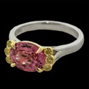 An absolutely stunning custom creation from Bridget Durnell. This ring is a one of a kind piece featuring a platinum shank with 18kt gold claw prongs holding a vivid 2.01ct Padparadscha sapphire. The sapphire is surrounded by six fancy intense yellow diamonds bezel set in yellow gold. Call for a custom quote. 