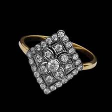 This whimsical and lovely 18K yellow and white gold ring fetures a floral diamond design (.48cts.tw.).
