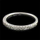 A 18kt white gold 1/2 shank diamond pave wedding band by Michael B from the new Touch Collection. This exquisite piece is set with 19 diamonds .25ct total. The ring measures 2.8mm in width. Will not catch fabric. Beautiful!