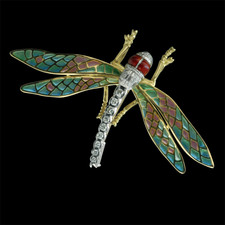This beautiful Dragon Fly brooch is done in 18kt yellow gold with plique d'jour wings and a diamond body.  The piece measures 40mm in length and 70mm in width.