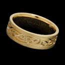 A smart 18kt gold "Celtic" band measuring 7mm in width. Deep engraving.  Available in white gold and platinum