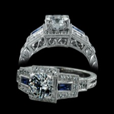 From Beverley K, this is an 18K Art Deco inspired ladies engagement ring. There are .26ctw of pave set diamonds and .38ctw of blue sapphires. The scroll design and etching on the sides of the band are hand engraved. Please call for center stone pricing.