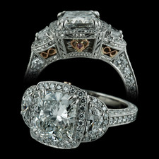 A beautiful handmade platinum diamond engagement ring from Beaudry. This ring features a 2.0ct cushion shaped diamond with 1/2ct half moon sides. Note the filigree heart with pink diamond and infinity symbols on either side. This was a custom created piece, please call for comparison pricing information.