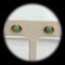 A pair of 14 kt. yellow gold jadite pierced earrings ca 1960's.  The earrings measure 11mm in diameter.