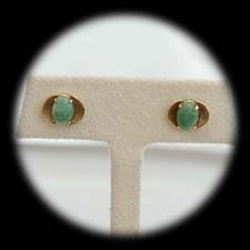 A pair of 14 kt. yellow gold jadite pierced earrings ca 1960's.  The earrings measure 11mm in diameter.