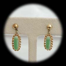 A nice pair of 18 kt. yellow gold jadite pierced earrings ca 1960's.  The earrings are set with a 13mm x 4mm jadite and are 26mm x 9mm overall.