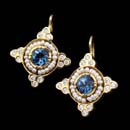 These beautiful earrings are 20kt yellow gold and contain seed pearls set around center round aquamarines. To the outside are fine round brilliant cut diamonds. The earrings have lever backs.
