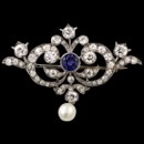 Belle Epoque circa 1910 diamond and sapphire platinum pin measuring 43 x 32mm.  The pin is set with 59 European cut, single cut diamonds weighing approx 2.25ct with center color change sapphire measuring 5mm. 6mm natural pearl.