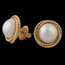 Gorgeous 14kt yellow gold and mabe pearl earrings. The earrings feature post backs and an intricate braided gold look. The pearls measure 11mm. 