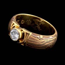 This ring by George Sawyer, in a suspended round setting with 18kt yellow red and 14kt gray gold plus the addition of copper. 7.0mm width. The ring can be sized for either a woman or man. Looks great both ways! Center diamond not included.