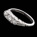 This beautiful Charles Green Victorian-inspired engagement ring shines with .25ctw of diamonds. The diamonds are intricately set in engraved 18kt white gold.