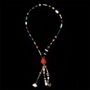A interesting Native American arts and crafts necklace measuring 37 inches. The piece is strung with rock crystal, turquoise, coral, tiger eye, shell, ivory, and Italian art glass beads. The large focal piece is a hand carved cinnabar ball.  Circa 1970's hippy style :-)