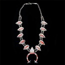 A rare early (pre 1950's) Native American silver and coral leaf squash blossom necklace.
The piece is set with 15 irregular oxblood natural coral bezel set cabochons. The overall length is 34 inch with the naja being 3 inches. Hard to find piece!