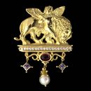 A fantastic display in 18kt gold... The cherub and lion are featured over a row of brilliant diamonds. The pin incorporates beautiful pink tourmailne and tanzanite, with a suspended pearl at the base of the piece.
