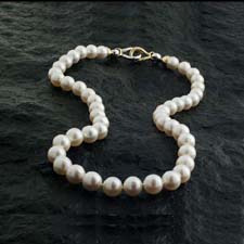 White south sea pearls with a two tone 18kt yellow gold clasp