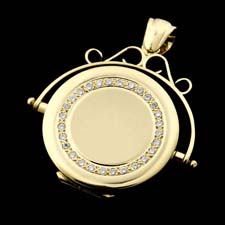 A beautiful 18kt gold and diamond locket. The circle part of the piece measures 24.0mm and contains .28ct. total weight in diamonds.