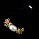 Nouveau Collection lovely pearl pendant is flanked by enamelled flowers. 18kt yellow gold.